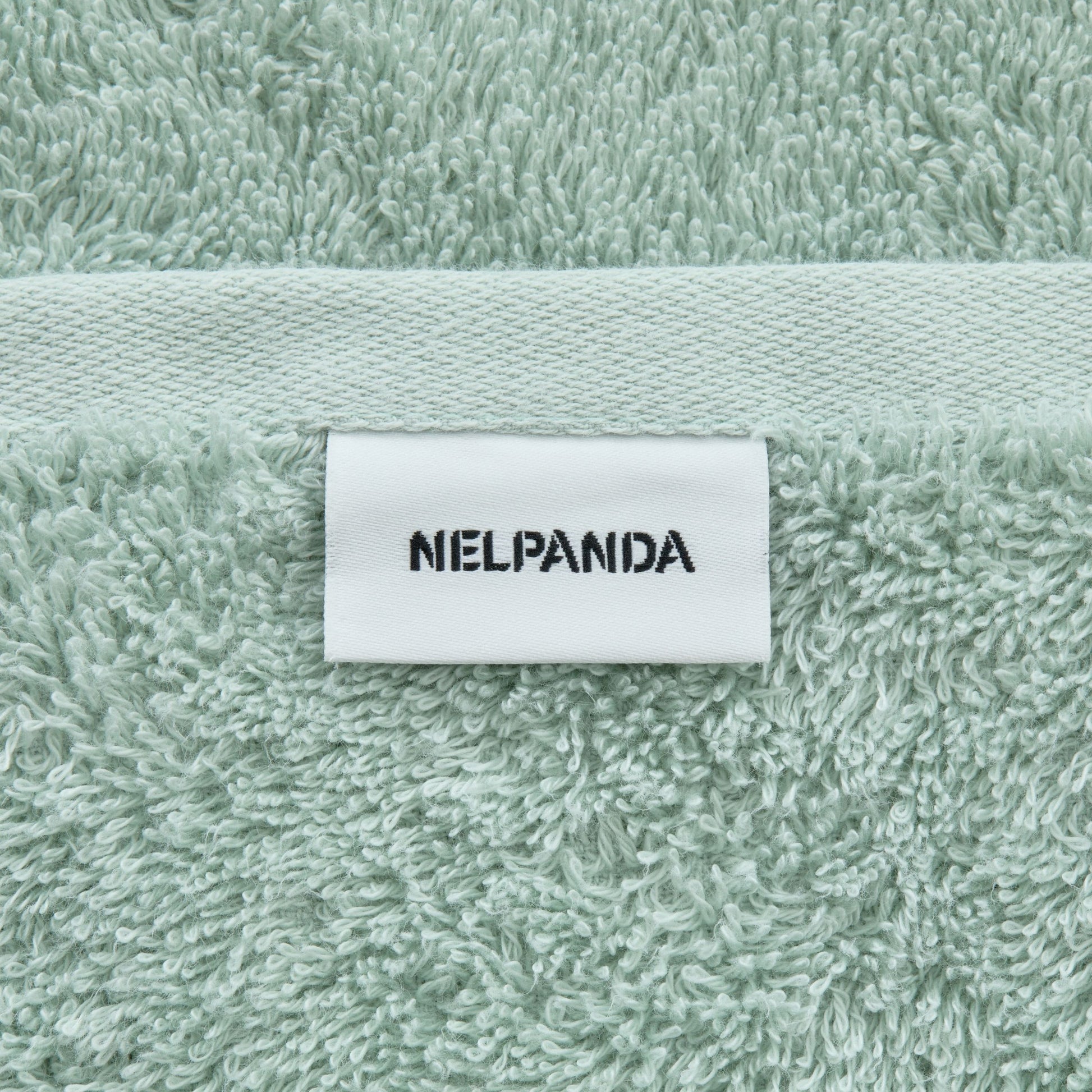 Green Egyptian cotton towel with a label displaying 'NIELPANDA' 