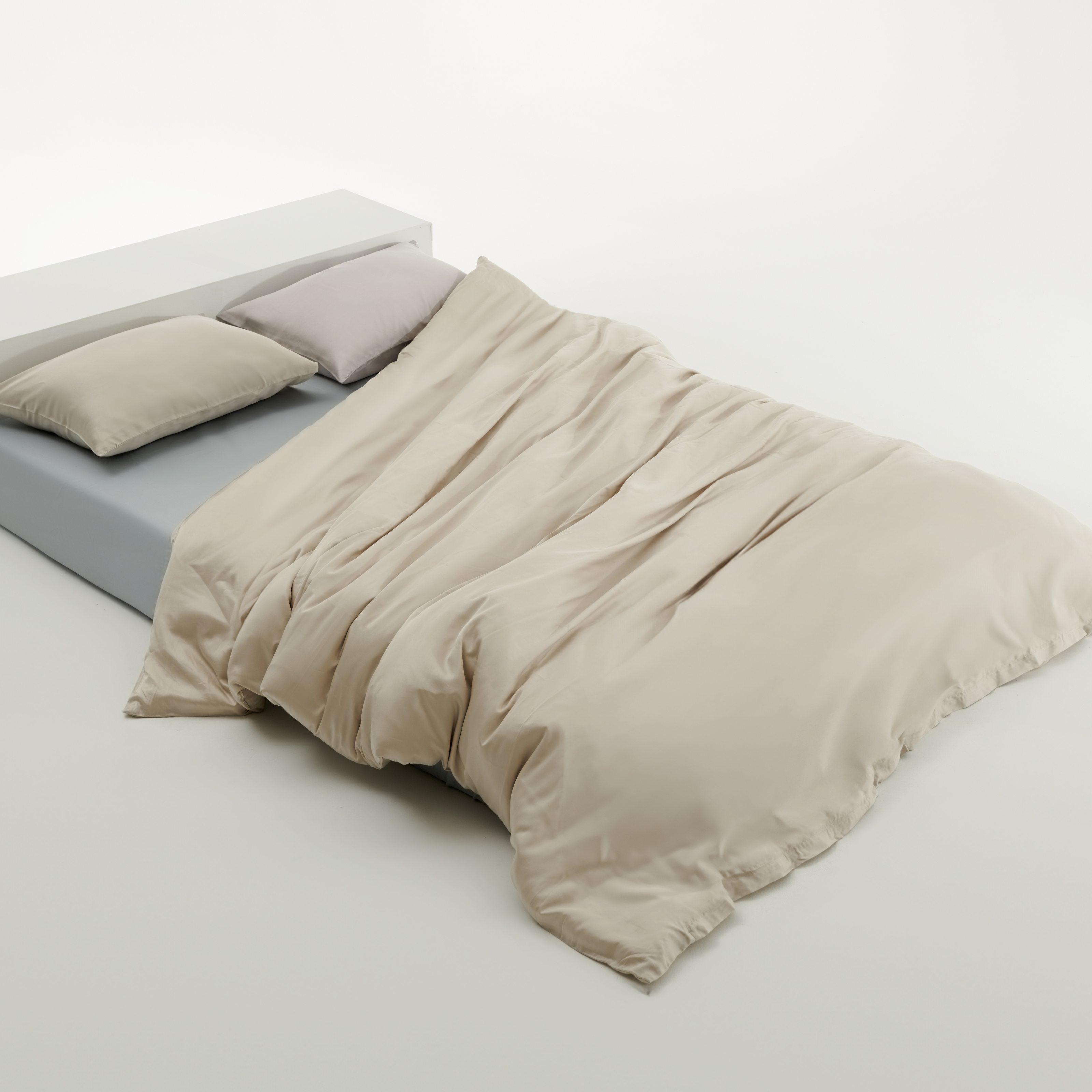  100% Tencel™ Lyocell fiber beige duvet cover, blue fitted sheet and green pillows