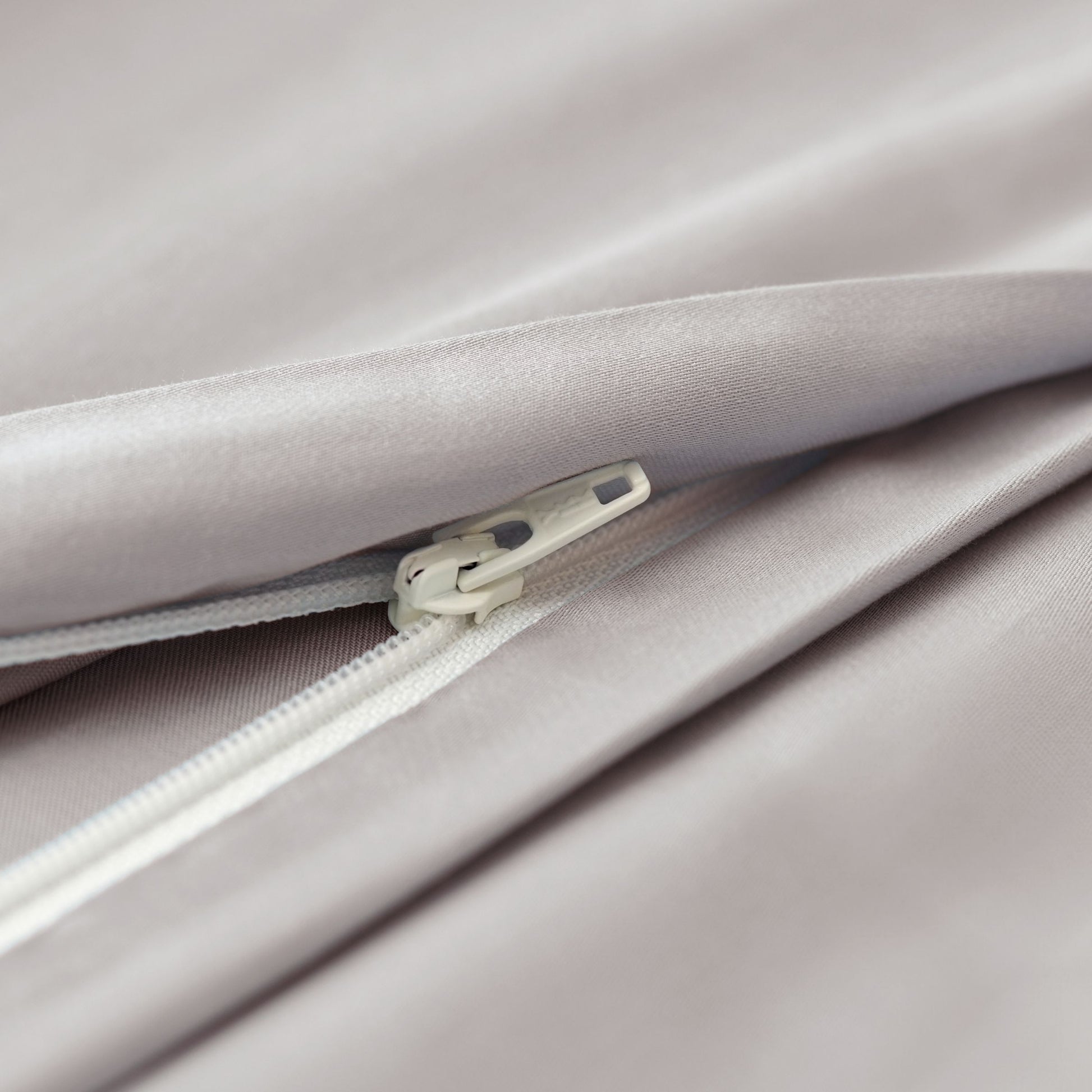 Close-up of a zipper on light gray 100% cotton duvet cover
