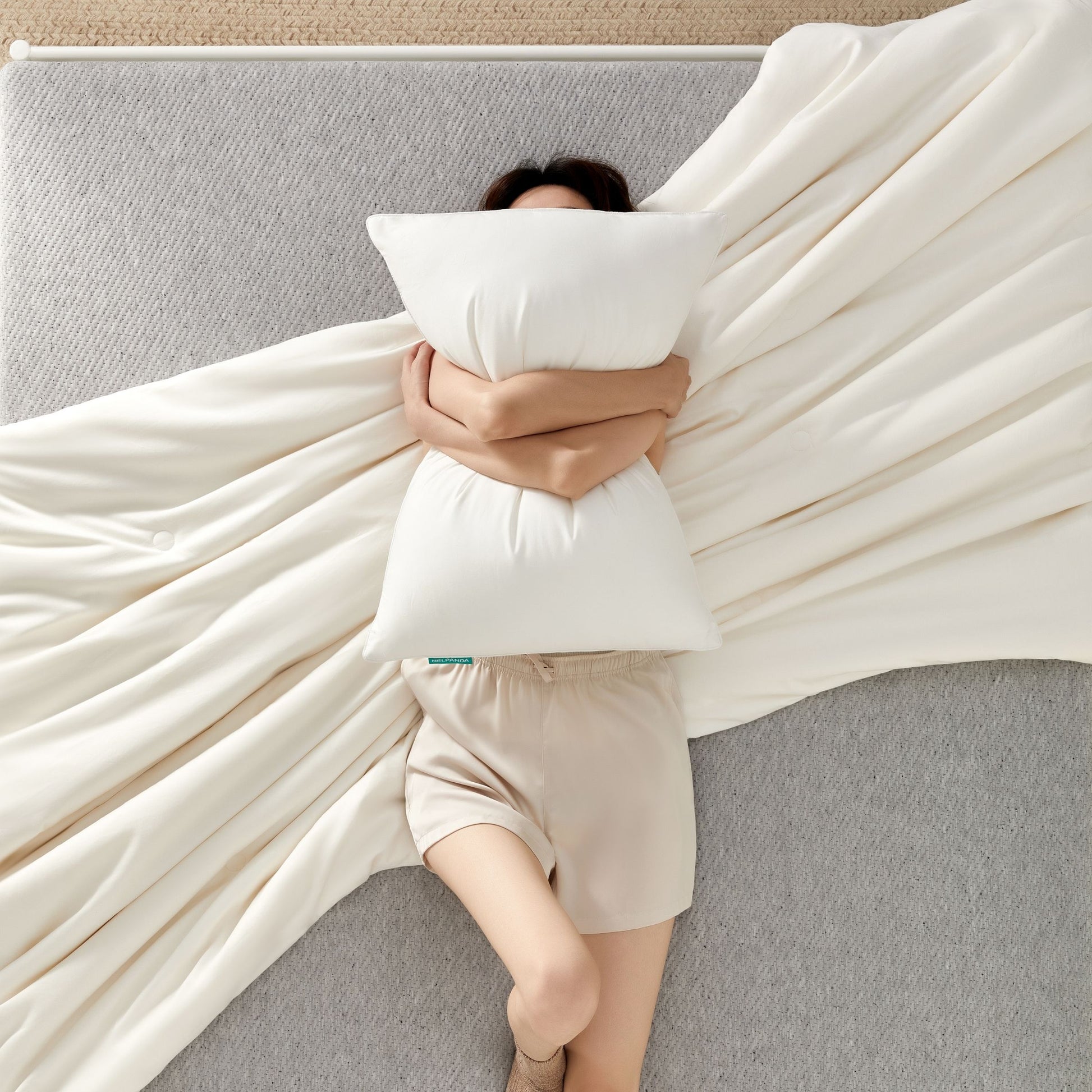 soft white pillowcase and silk duvet on a modern bed